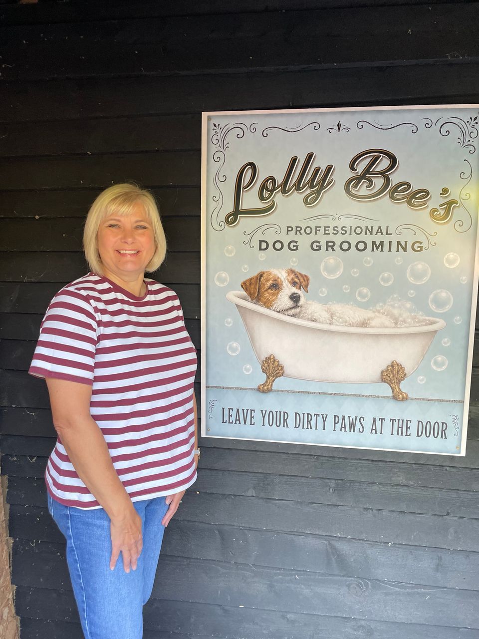 Karen standing beside the Lolly Bee's sign outside the lodge