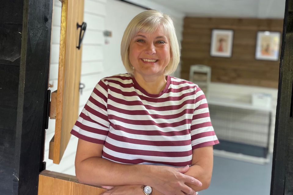 Karen leaning on the stable door of the grooming lodge
